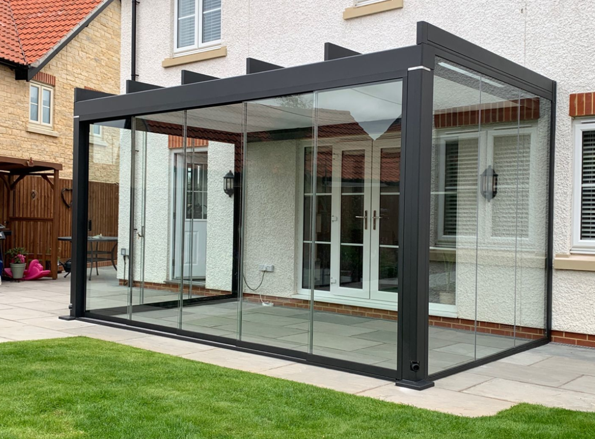Exterior view of a fully enclosed glass room extension